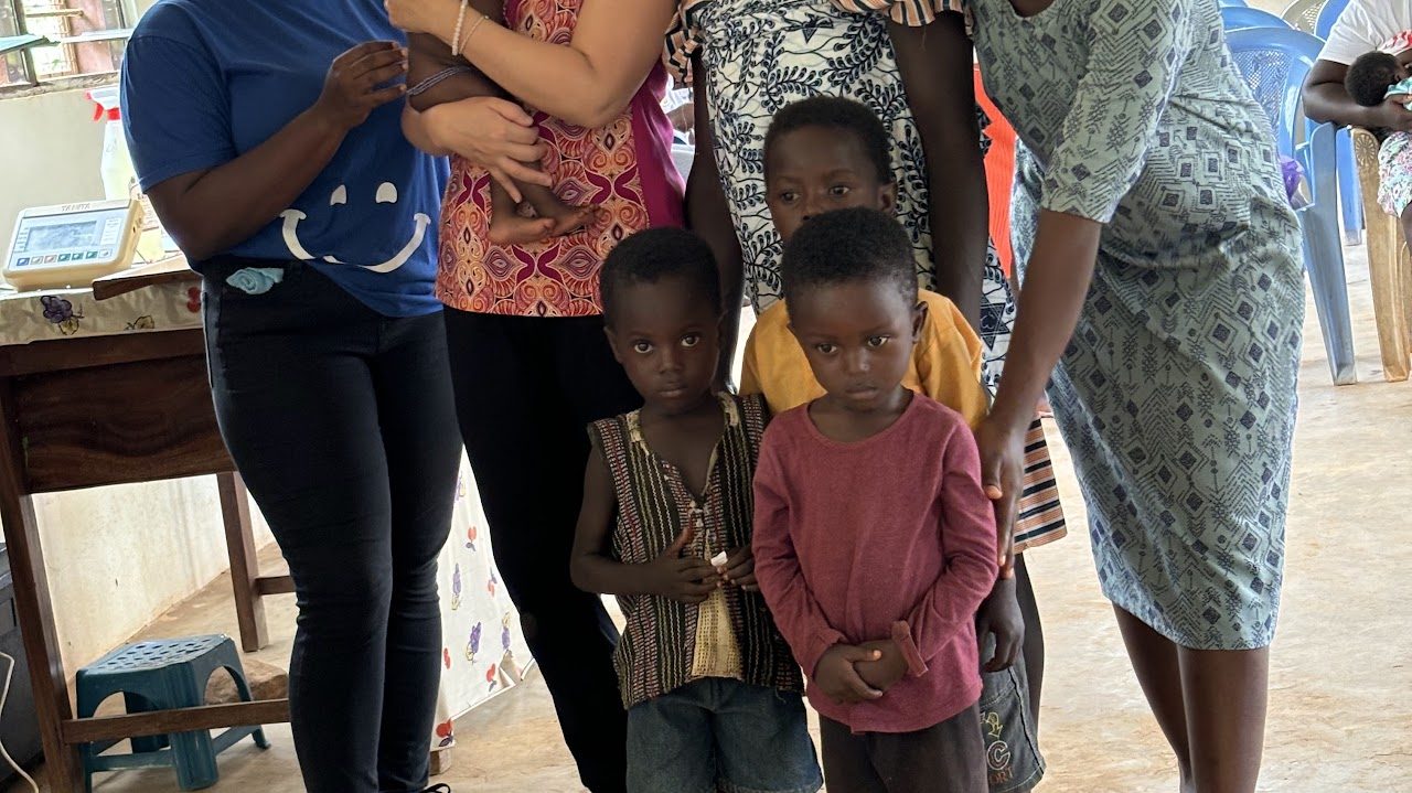 Children and women at a community nutrition session in Ghana