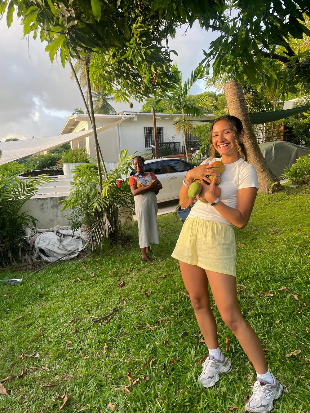 AWIN grant recipient Lupita Silva holding fresh-picked mangos in Barbados